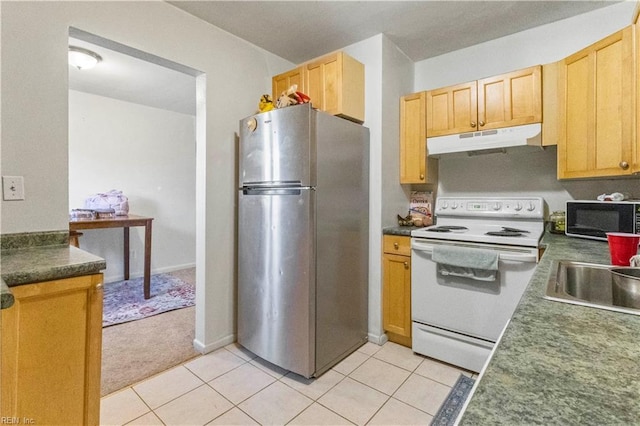 kitchen with white range with electric cooktop, freestanding refrigerator, a sink, black microwave, and under cabinet range hood