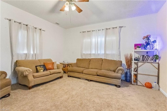 carpeted living room with ceiling fan