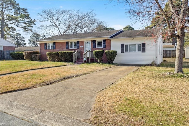 single story home with brick siding, concrete driveway, a front yard, and fence