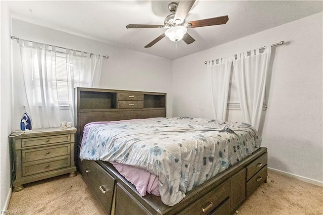 bedroom with baseboards, light colored carpet, and ceiling fan