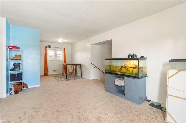 interior space with carpet and an upstairs landing