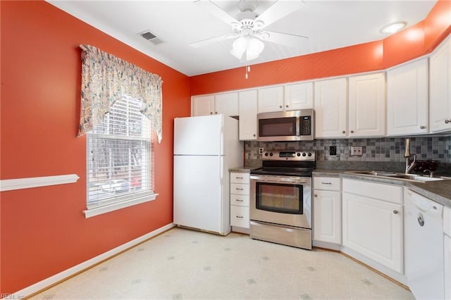 kitchen with a sink, visible vents, appliances with stainless steel finishes, and white cabinetry