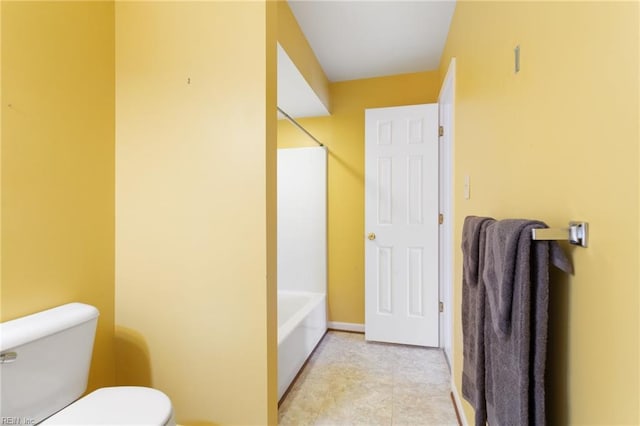 bathroom featuring shower / bathing tub combination and toilet