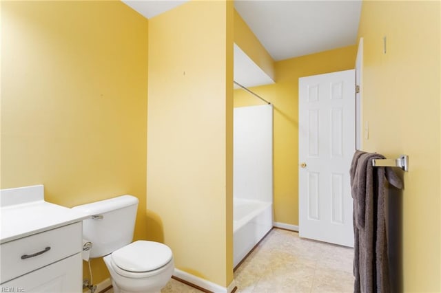 bathroom featuring vanity, bathing tub / shower combination, toilet, and baseboards