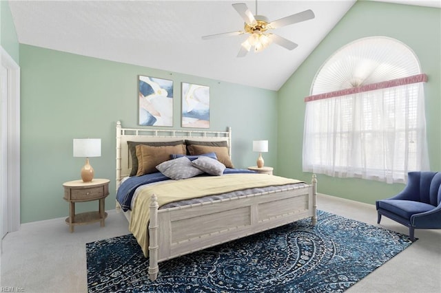 bedroom featuring a ceiling fan, lofted ceiling, and carpet