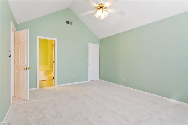 unfurnished bedroom with visible vents, light colored carpet, high vaulted ceiling, and baseboards