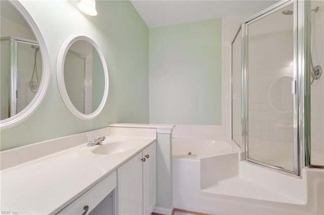 full bathroom featuring vanity, a bath, and a shower with door