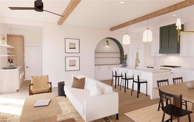 living area with beamed ceiling, recessed lighting, light wood-type flooring, and a ceiling fan