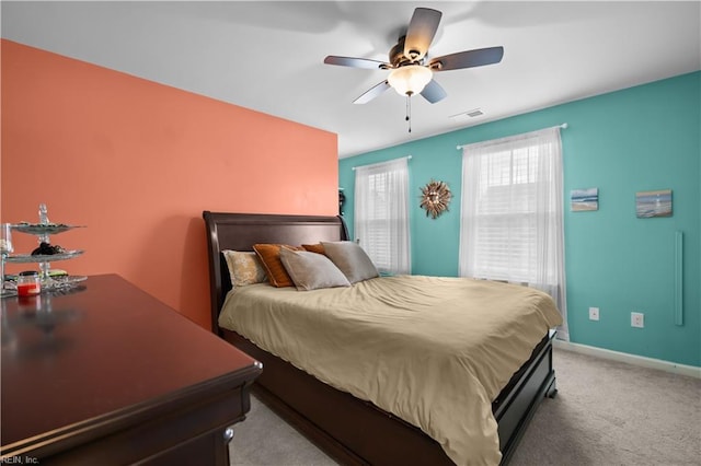 bedroom with light carpet, visible vents, ceiling fan, and baseboards