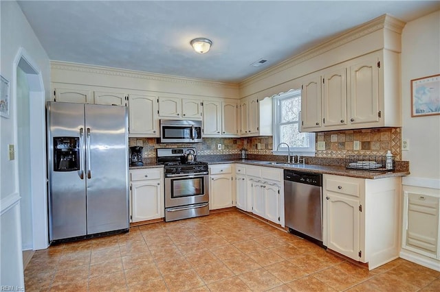 kitchen with tasteful backsplash, visible vents, light tile patterned floors, appliances with stainless steel finishes, and a sink