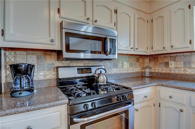 kitchen with white cabinetry, backsplash, and appliances with stainless steel finishes