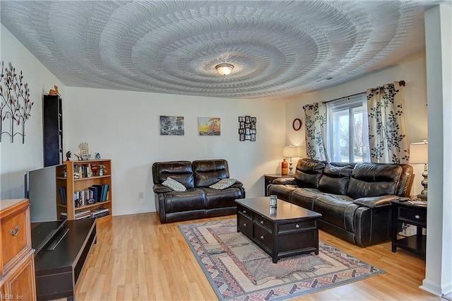 living area featuring light wood-style flooring and a textured ceiling