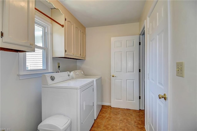 washroom with light tile patterned floors, cabinet space, washer and dryer, and baseboards