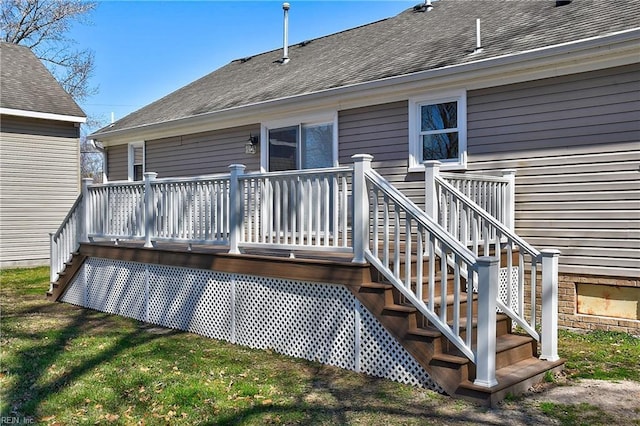 back of property featuring stairway, roof with shingles, and a wooden deck