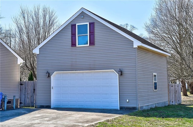 exterior space with a garage and fence