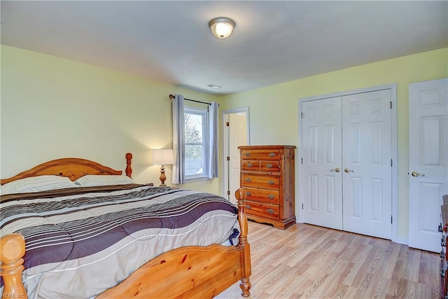 bedroom with a closet and light wood finished floors