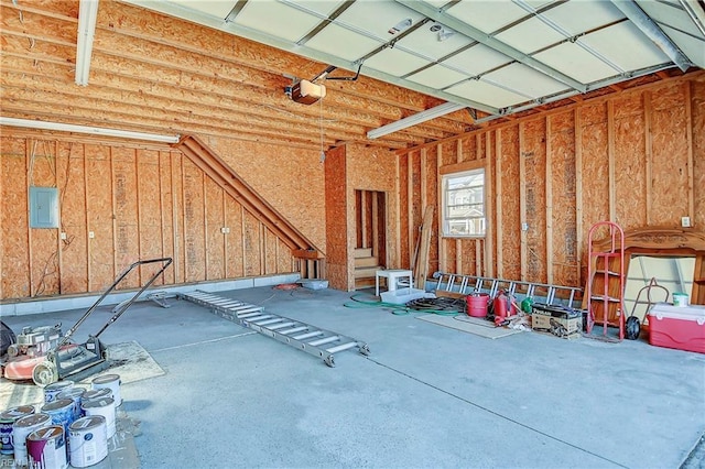 garage featuring electric panel and a garage door opener