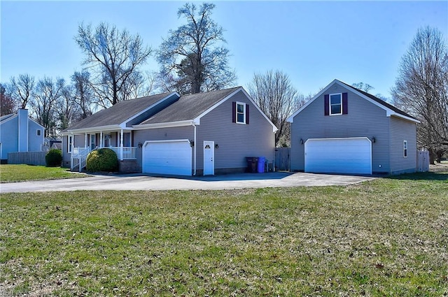 view of front facade with a garage, driveway, a front lawn, and fence