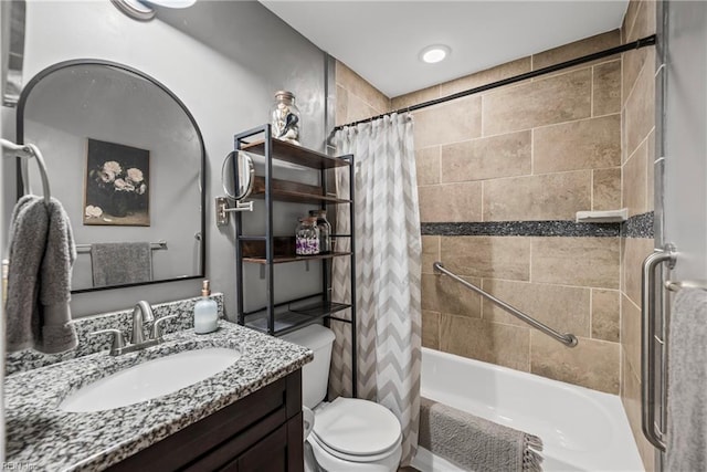 bathroom featuring vanity, shower / tub combo, and toilet