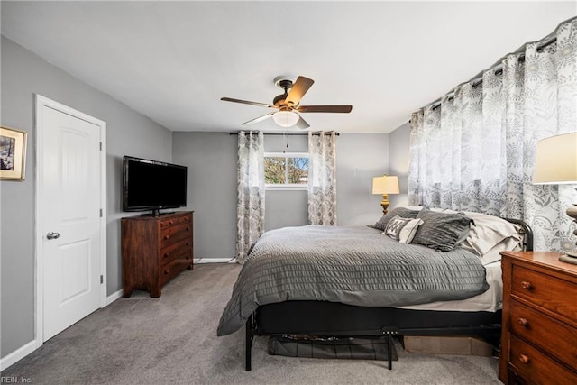 carpeted bedroom featuring a ceiling fan and baseboards