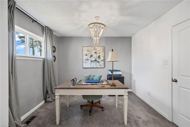 office with a textured ceiling, carpet flooring, visible vents, and a chandelier