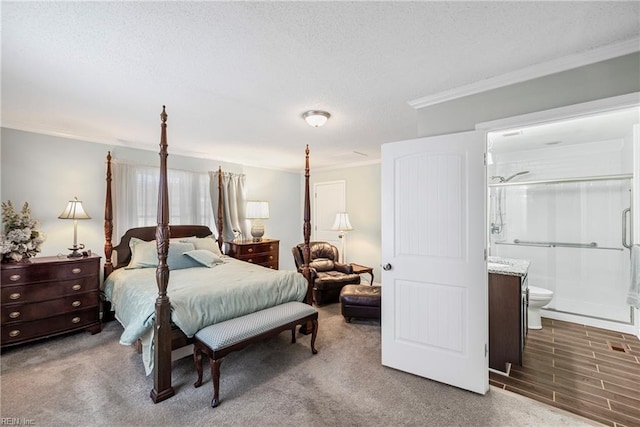 bedroom featuring ensuite bathroom, a textured ceiling, and crown molding