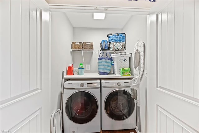 clothes washing area featuring laundry area and washer and clothes dryer