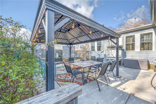 view of patio with a gazebo and outdoor dining area