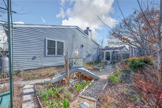 rear view of property with a chimney