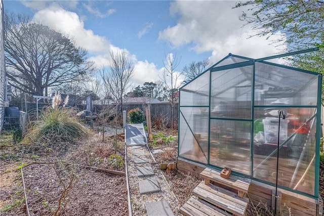 view of yard featuring an exterior structure, an outdoor structure, and fence