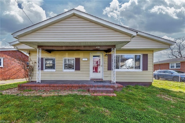 bungalow with a front lawn and a porch