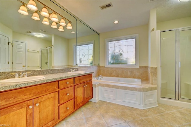 bathroom with tile patterned floors, a stall shower, visible vents, and a sink