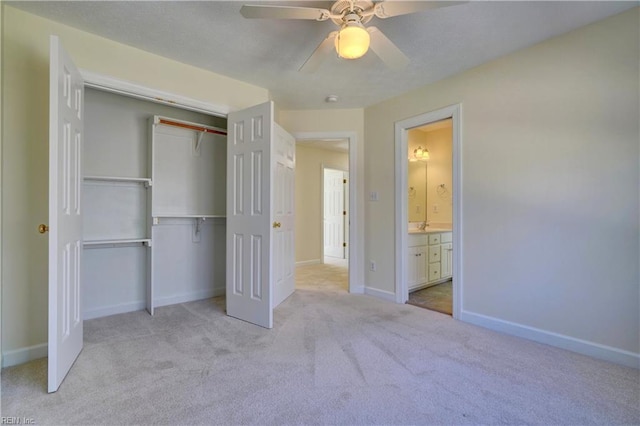 unfurnished bedroom with a closet, baseboards, carpet floors, and a ceiling fan