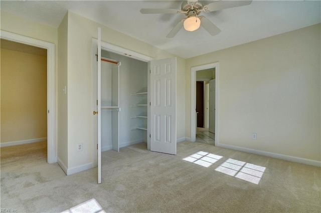 unfurnished bedroom featuring carpet flooring, baseboards, a closet, and ceiling fan