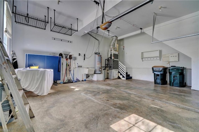 garage featuring heating unit, a garage door opener, and water heater