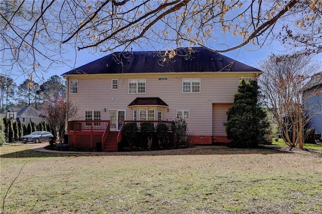 back of property with crawl space, a lawn, and a deck