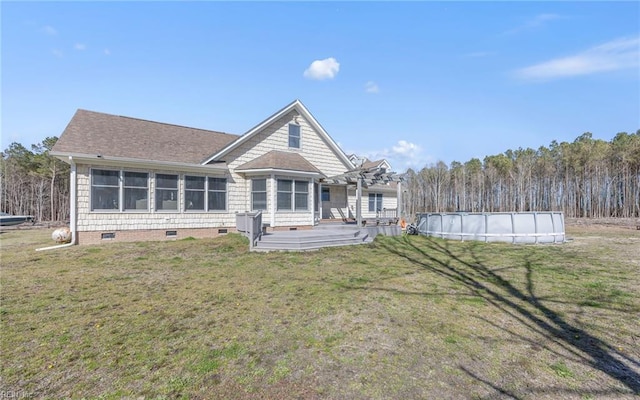 back of house with an outdoor pool, a pergola, a shingled roof, crawl space, and a lawn