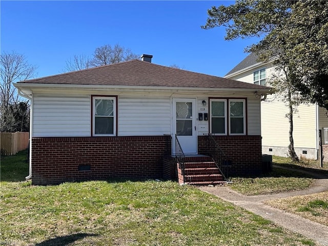 bungalow-style home featuring crawl space, entry steps, a front lawn, and brick siding