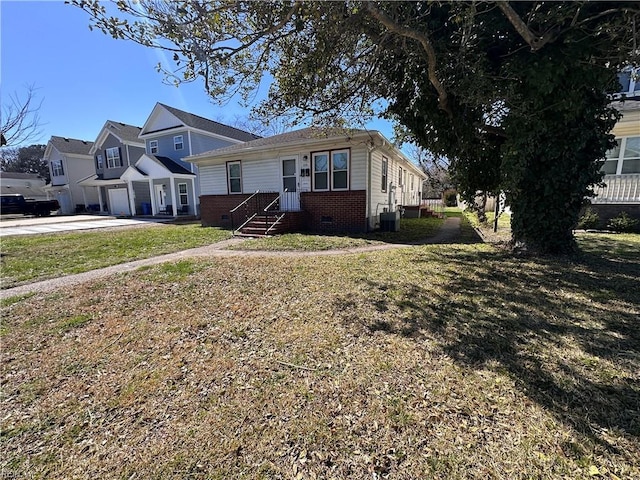 view of front of property with a front lawn, brick siding, and crawl space