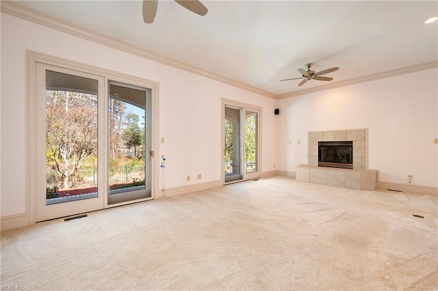 unfurnished living room featuring crown molding, carpet, visible vents, and ceiling fan