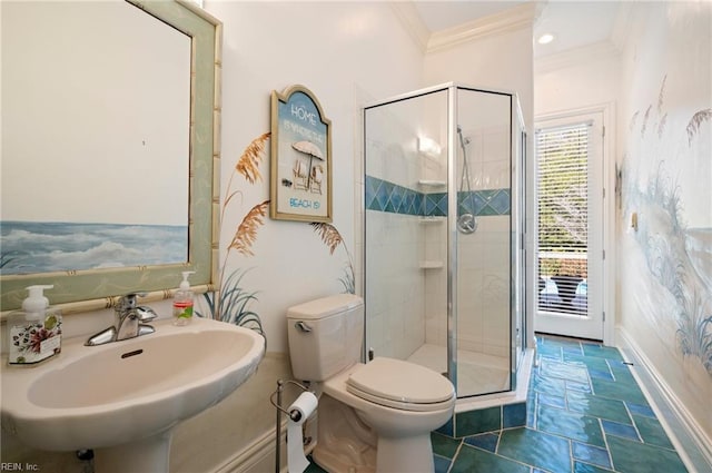 bathroom featuring crown molding, baseboards, toilet, a stall shower, and a sink