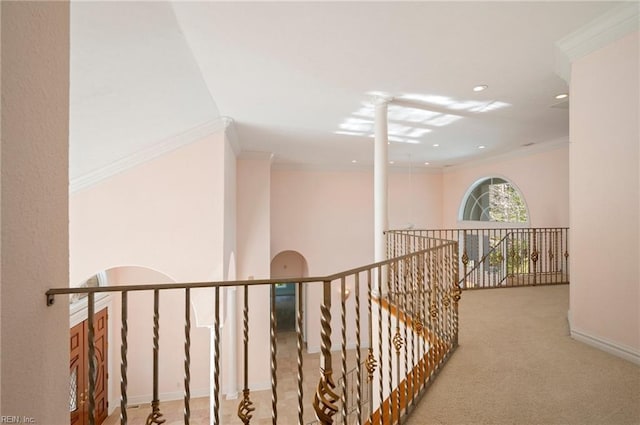 hallway with baseboards, carpet floors, and crown molding