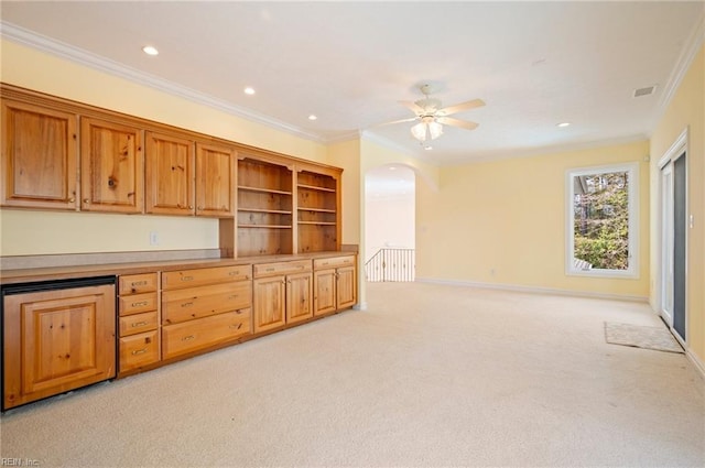 interior space with visible vents, ornamental molding, open shelves, light colored carpet, and ceiling fan