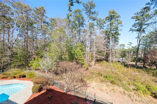 view of yard featuring a fenced in pool and fence