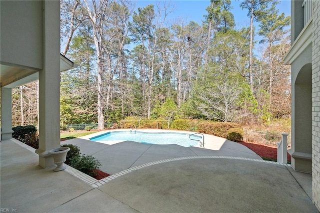 view of pool featuring a patio, a fenced in pool, and fence