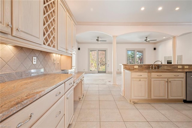 kitchen with a ceiling fan, arched walkways, and ornate columns