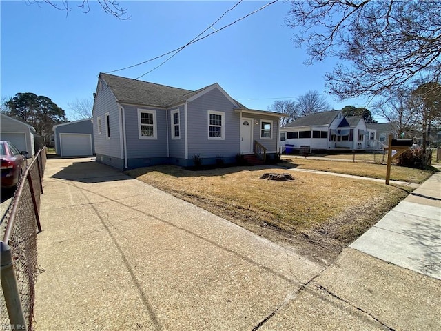 view of front of house featuring entry steps, a garage, an outdoor structure, crawl space, and driveway