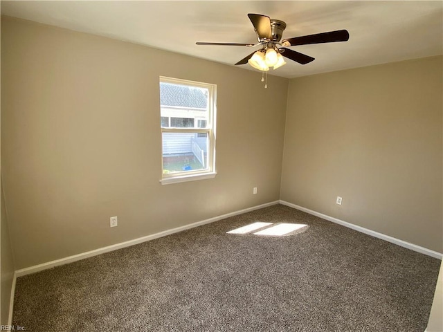 spare room featuring carpet flooring, ceiling fan, and baseboards