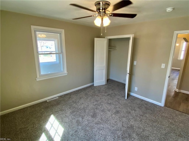 unfurnished bedroom featuring carpet, baseboards, visible vents, ceiling fan, and a closet