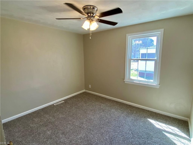 unfurnished room with visible vents, baseboards, carpet floors, and a ceiling fan